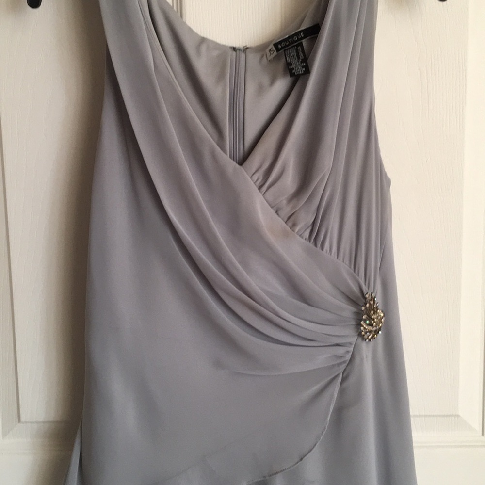 Silver silk gown with brooch